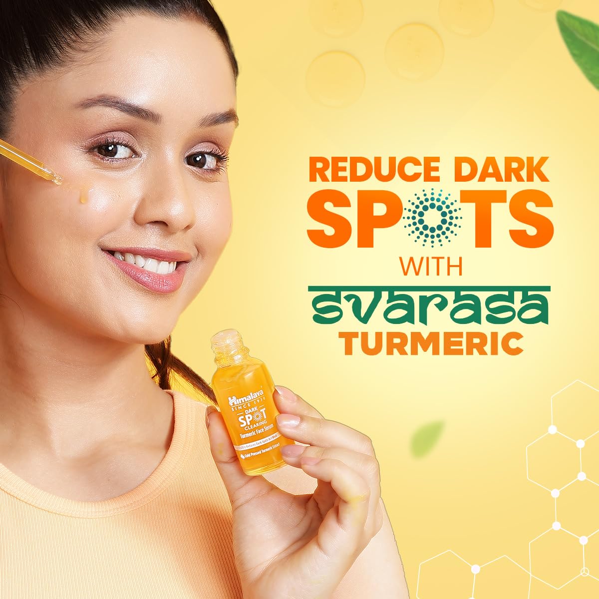 Woman holding the Himalaya Dark Spot Clearing Turmeric Face Serum bottle - reduce dark spots with Svarasa turmeric