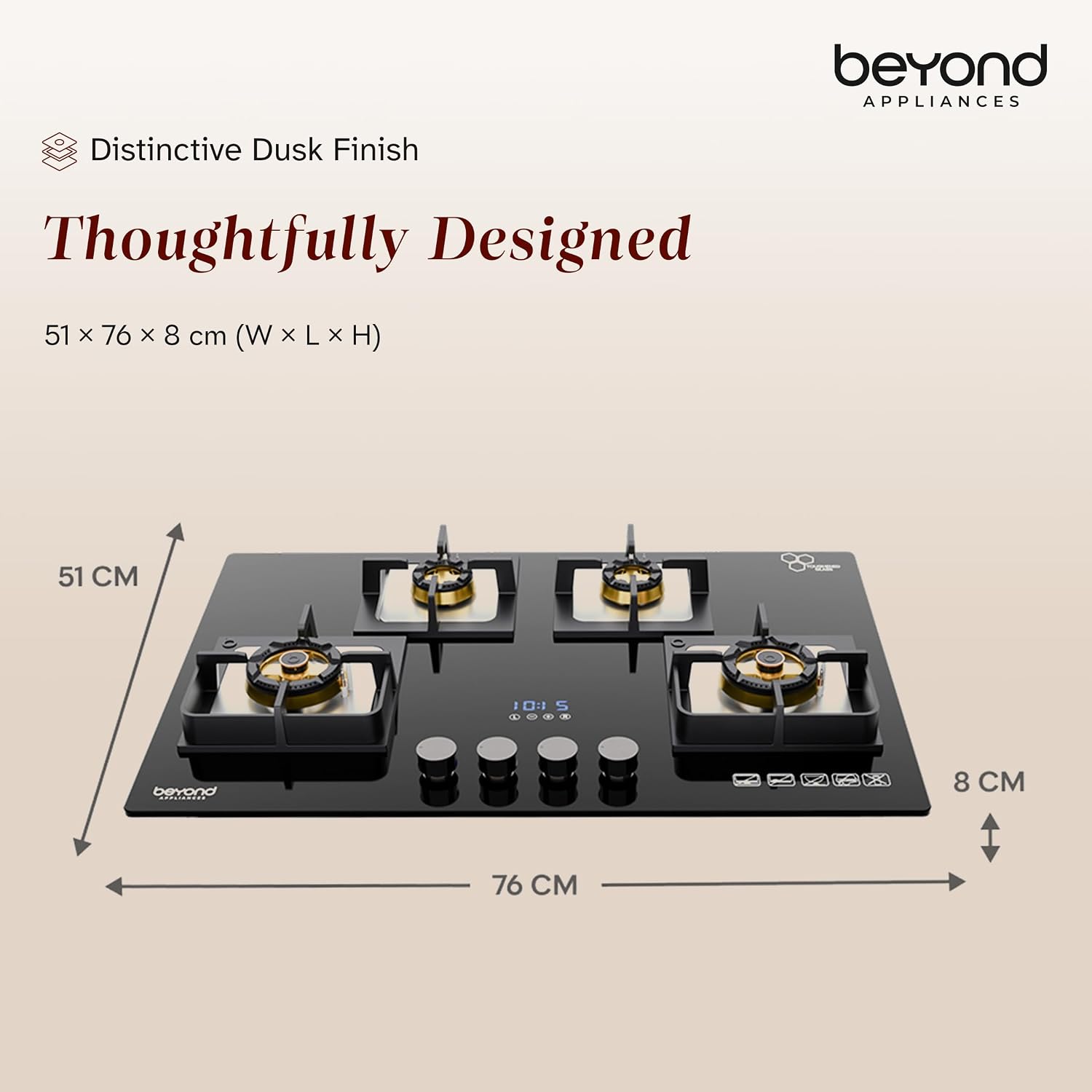 The Beyond Dorado hobtop in a modern kitchen. Fitted into a marble countertop with warm wood-toned cabinets, the black glass top, gold-toned burners and compact control panel suit both contemporary and classic interiors. Knobs sit along the front edge with the timer display beside them, practical enough for everyday Indian cooking.